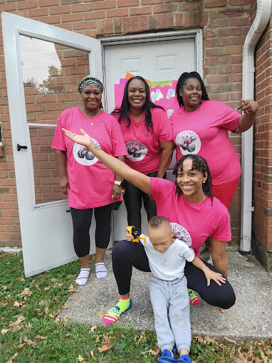 A group of women in pink shirts posing for a picture