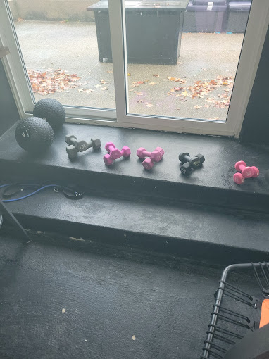 A window sill with a bunch of little pink and black balls on it